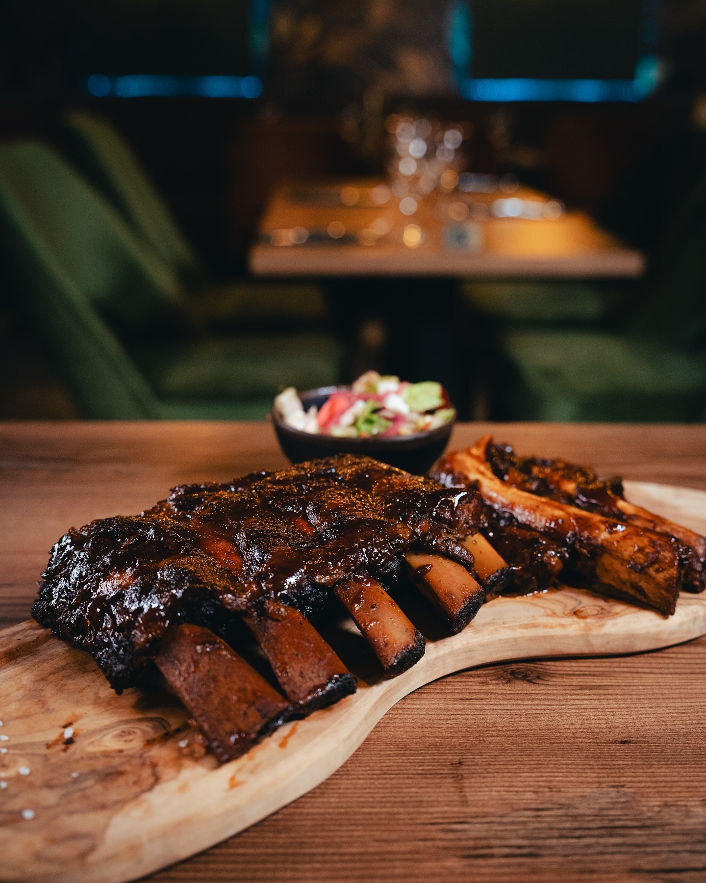 A plate of smoked ribs with a rich glaze and a side salad at Seventeen, a halal restaurant in Antwerpen, Belgium.