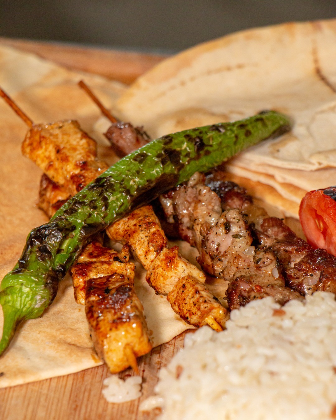 A plate of grilled meat skewers, rice, and flatbread at Lale, a halal restaurant in Schaerbeek, Belgium.