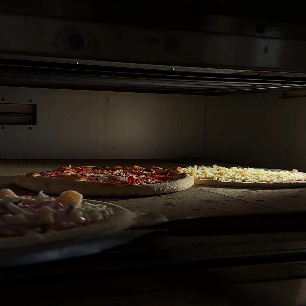 A pizza with various toppings at GIA Restaurant, a halal restaurant in Amsterdam, Netherlands.
