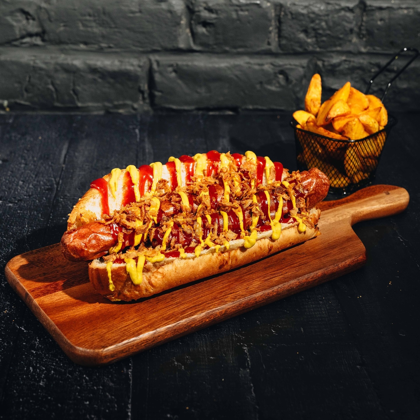 A hot dog topped with ketchup, mustard, and crispy onions at Le Passage, a halal restaurant in Molenbeek-Saint-Jean, Belgium.
