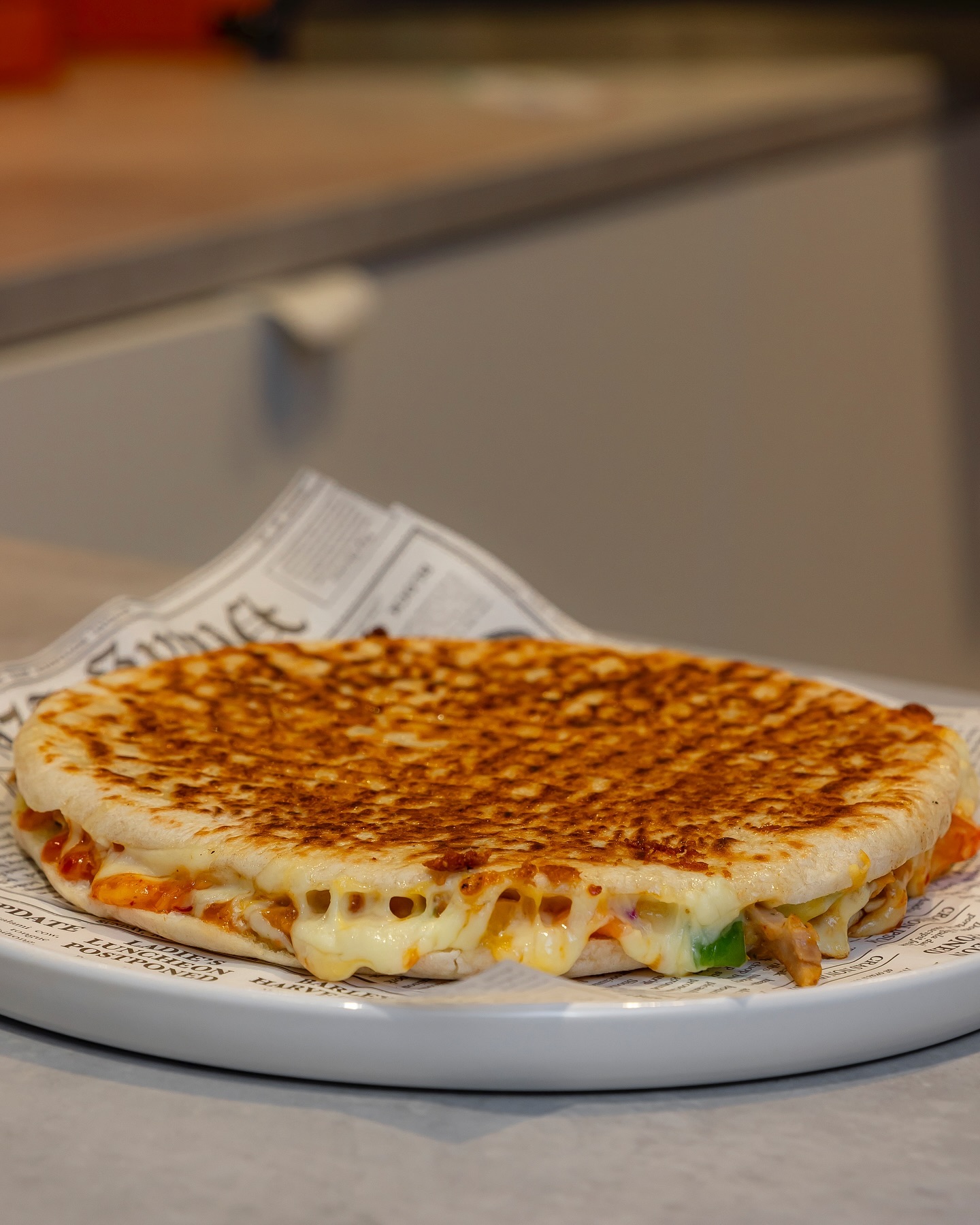 A grilled flatbread filled with cheese and vegetables at Toastup, a halal restaurant in Rotterdam, Netherlands.