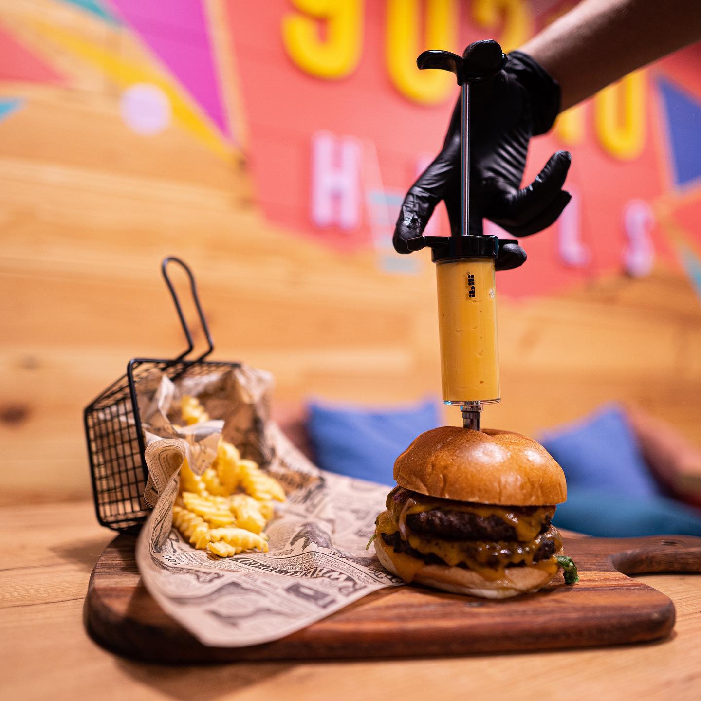 A cheeseburger with a cheese injector and crinkle fries at Peach Pit, a halal restaurant in Schaerbeek, Belgium.