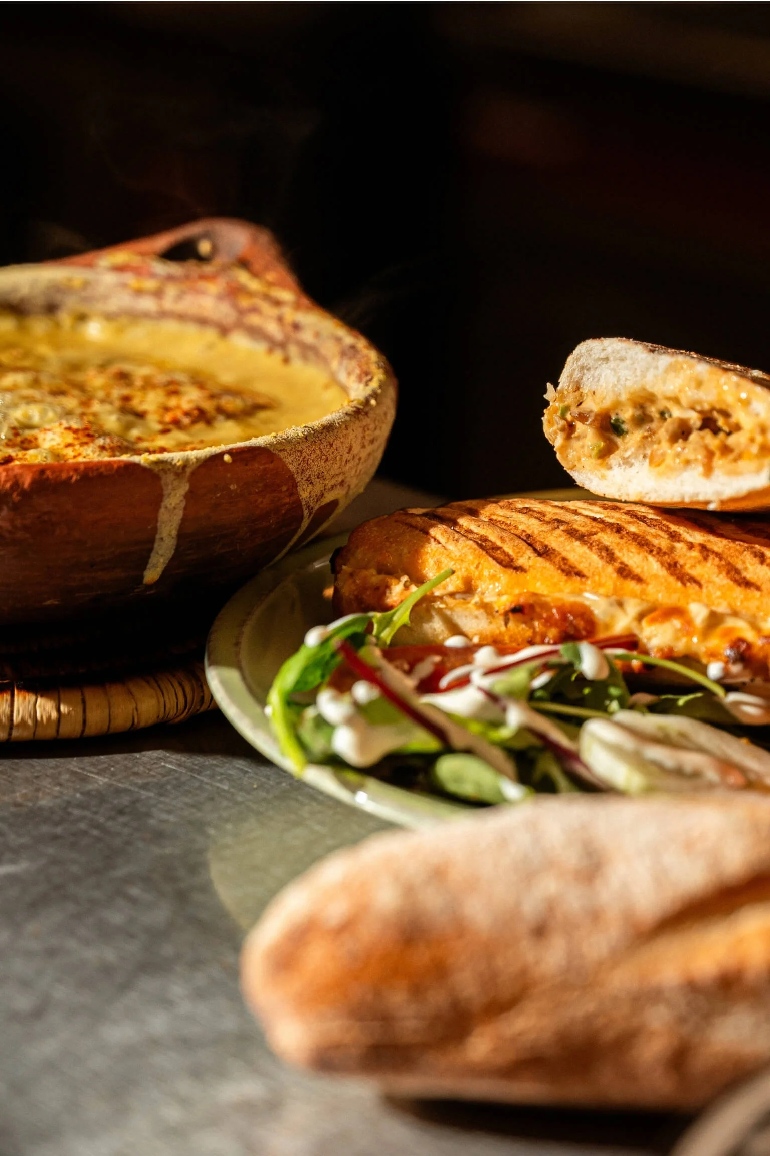 A bowl of creamy soup and a grilled sandwich with a side salad at Lella, a halal restaurant in Antwerpen, Belgium.