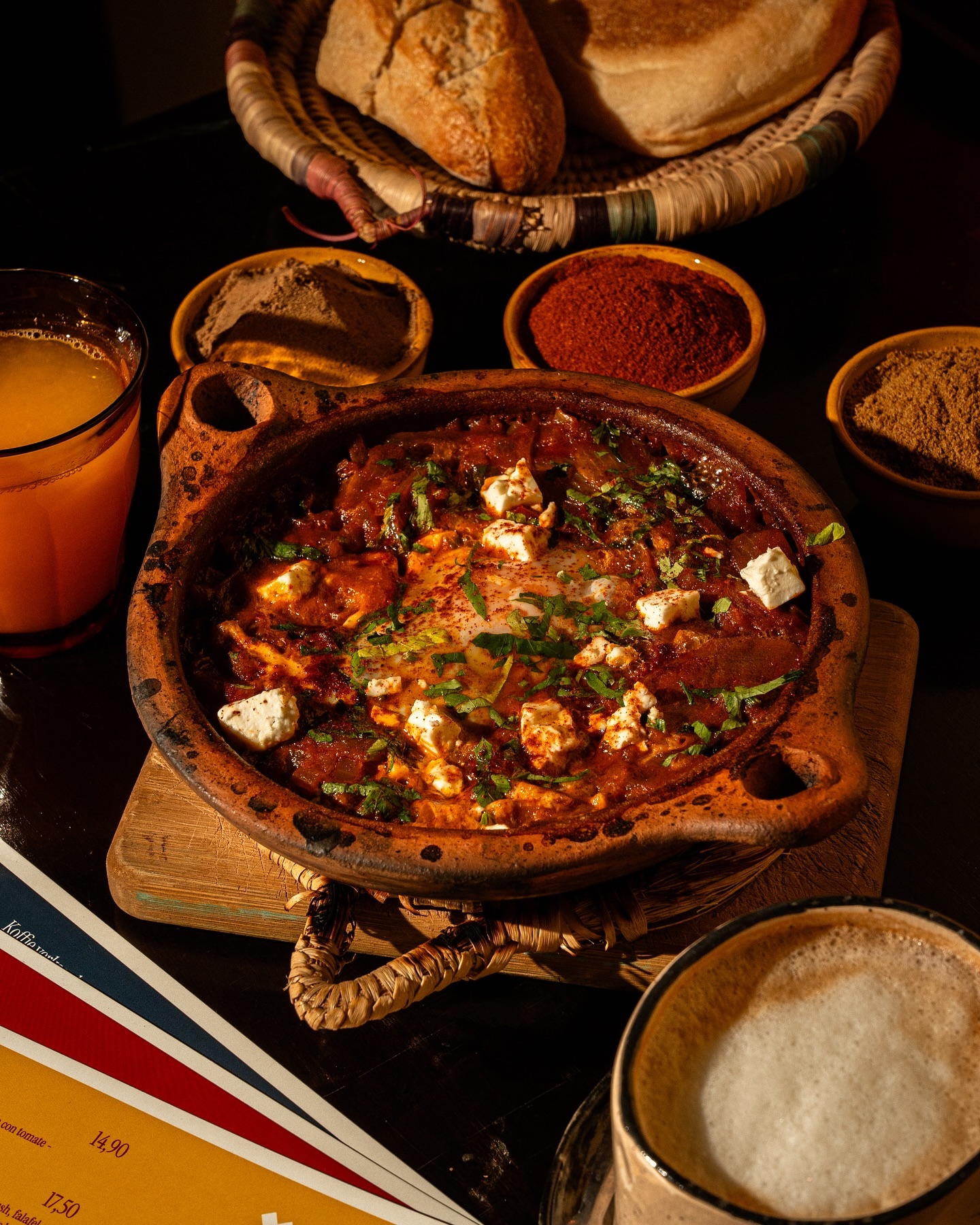 A clay pot of shakshuka with eggs, cheese, and herbs at Lella, a halal restaurant in Antwerpen, Belgium.