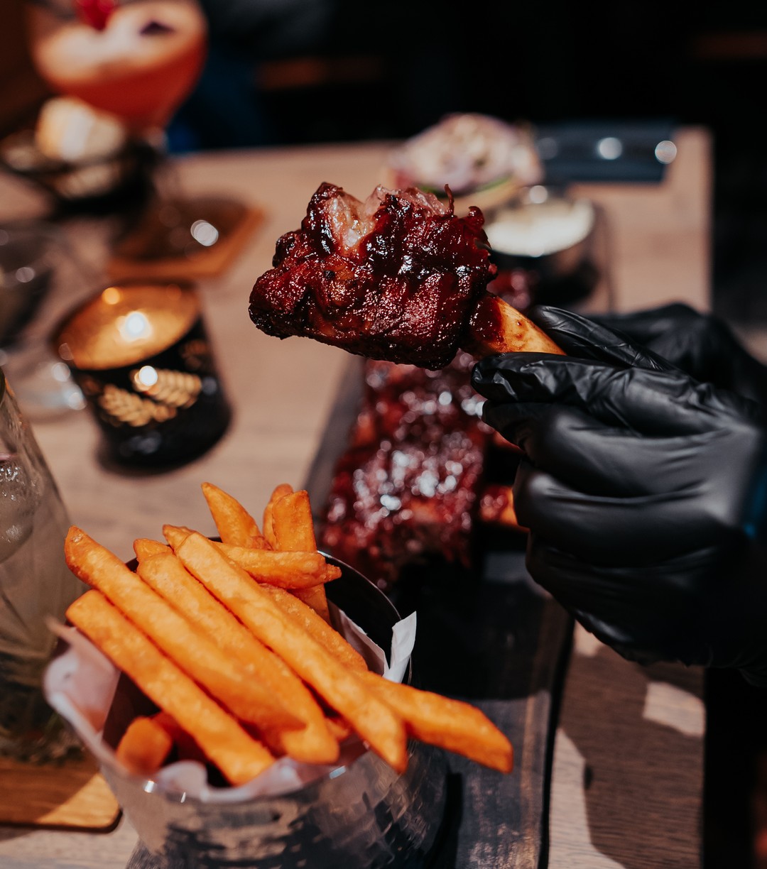 A plate of sweet potato fries and glazed chicken wings at La Ruche, a halal restaurant in Bruxelles, Belgium.