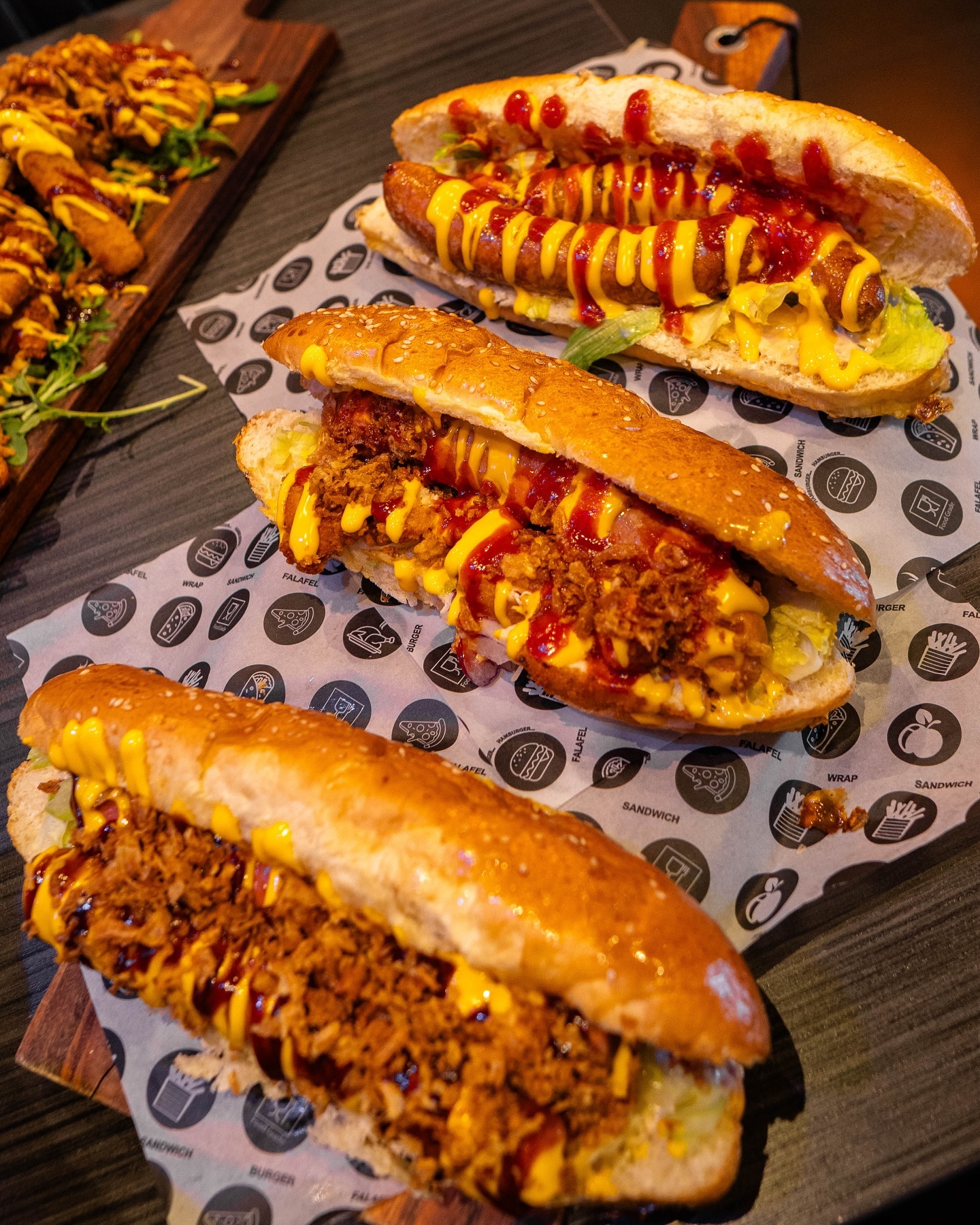 A plate of three different hot dogs topped with mustard and ketchup at Food Korner, a halal restaurant in Anderlecht, Belgium.
