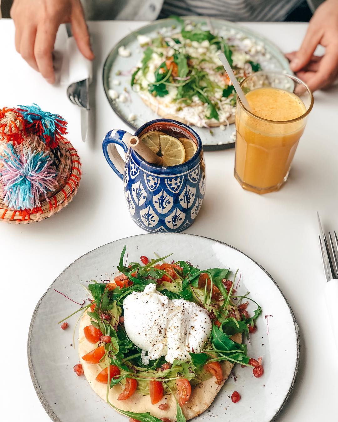 A plate of salad with poached egg, cherry tomatoes, and greens at Felfel, a halal restaurant in Antwerpen, Belgium.