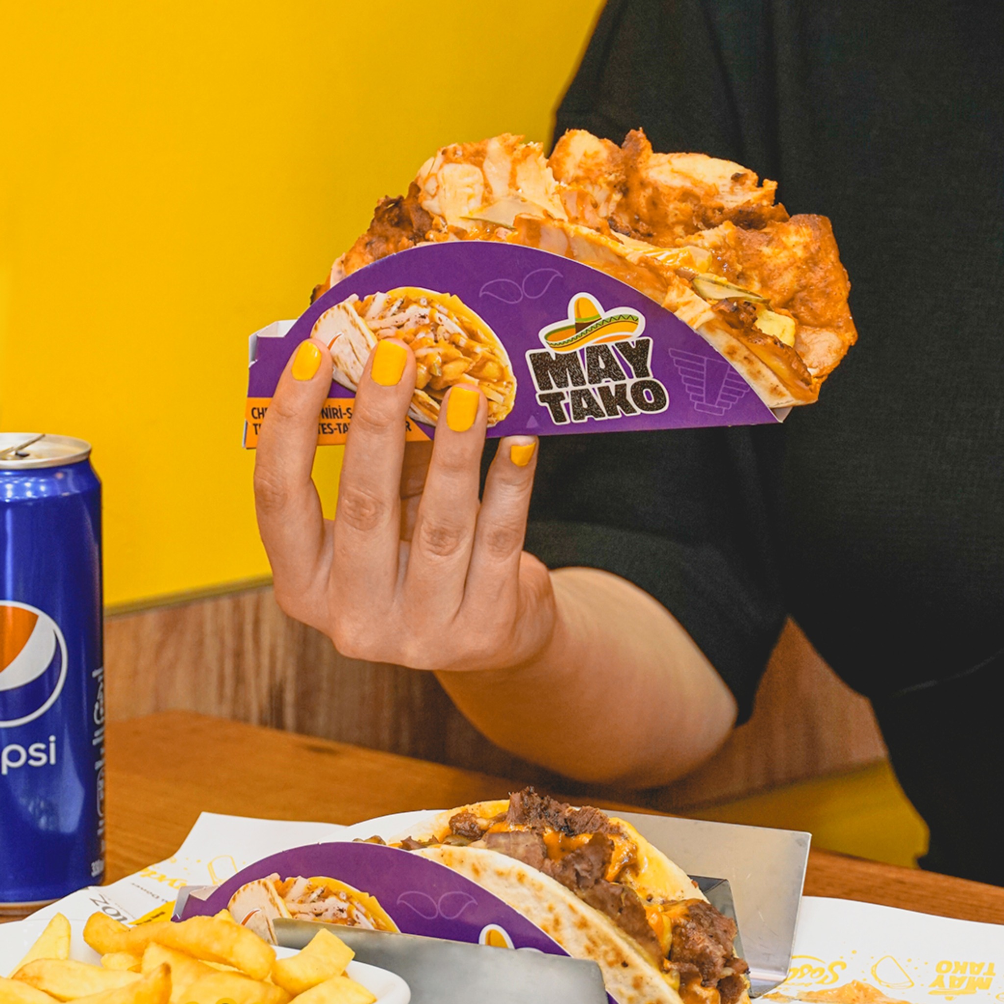 A taco filled with chicken and toppings at May Tacos, a halal restaurant in Den Haag, Netherlands.