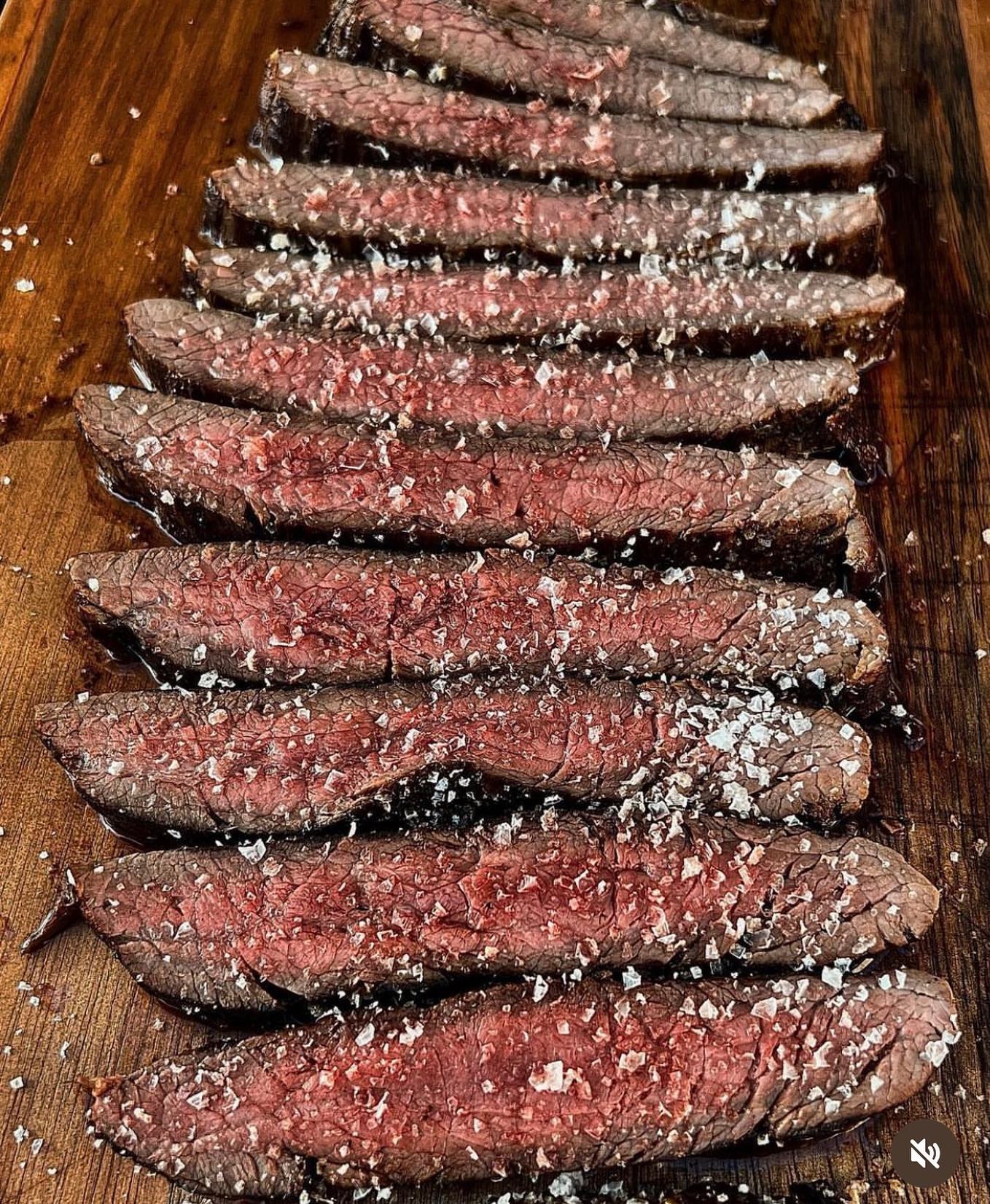 A sliced steak with a pink interior and coarse salt on top at Konak Steakhouse, a halal restaurant in Destelbergen, Belgium.