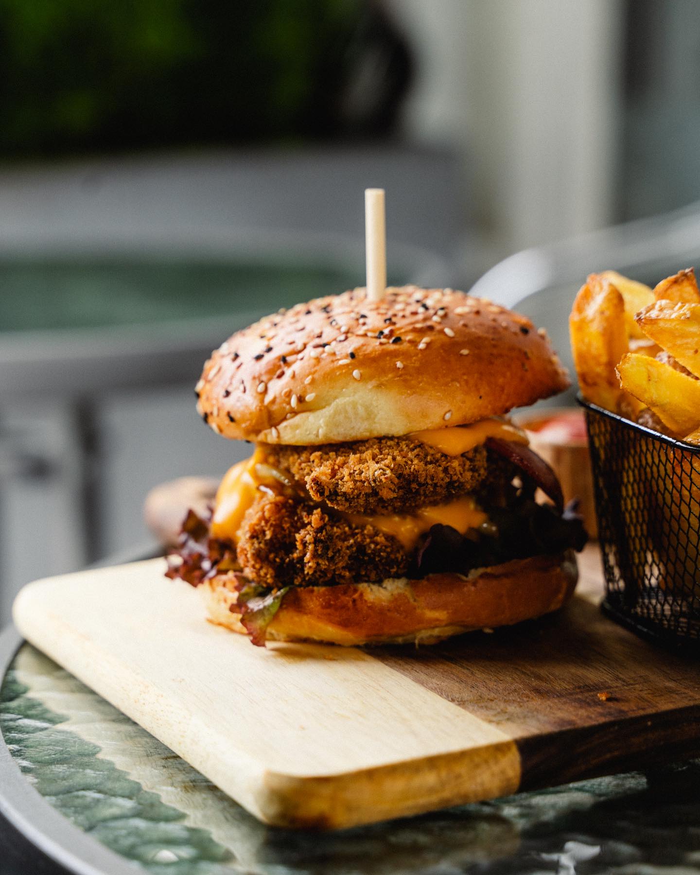 A crispy fried chicken burger with melted cheese and lettuce at Taco's and burgers, a halal restaurant in Amsterdam, Netherlands.