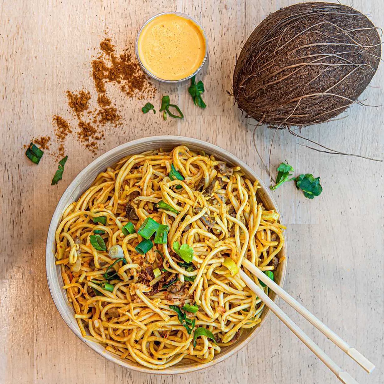 A bowl of stir-fried noodles with vegetables and herbs at YouWok, a halal restaurant in Wijnegem, Belgium.