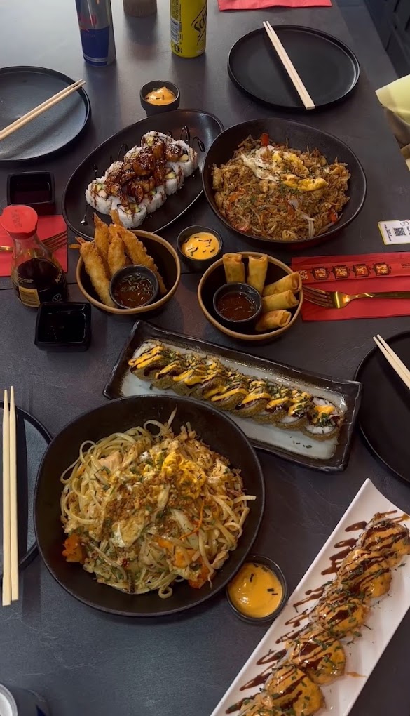 A variety of Asian dishes including sushi, fried rice, spring rolls, and noodles at Wokbox, a halal restaurant in Antwerpen, Belgium.