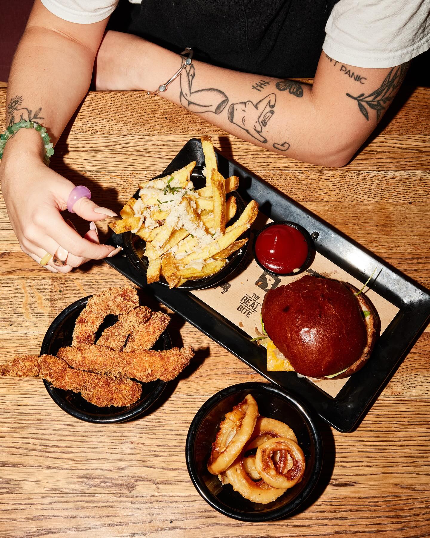 A plate of fries, crispy chicken strips, onion rings, and a burger at Burger Bar, a halal restaurant in Amsterdam, Netherlands.