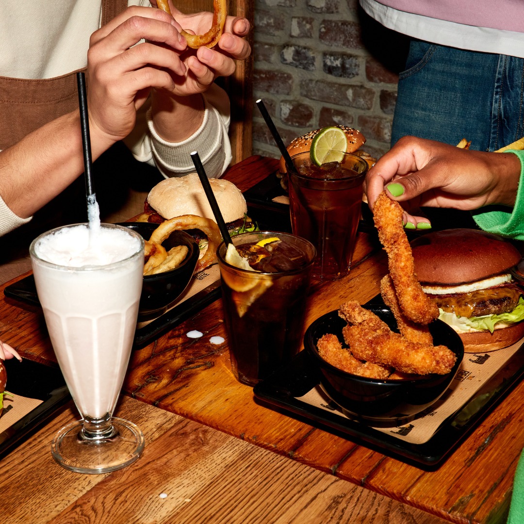 A variety of dishes including burgers, fried chicken, and milkshakes at Burger Bar, a halal restaurant in Amsterdam, Netherlands.