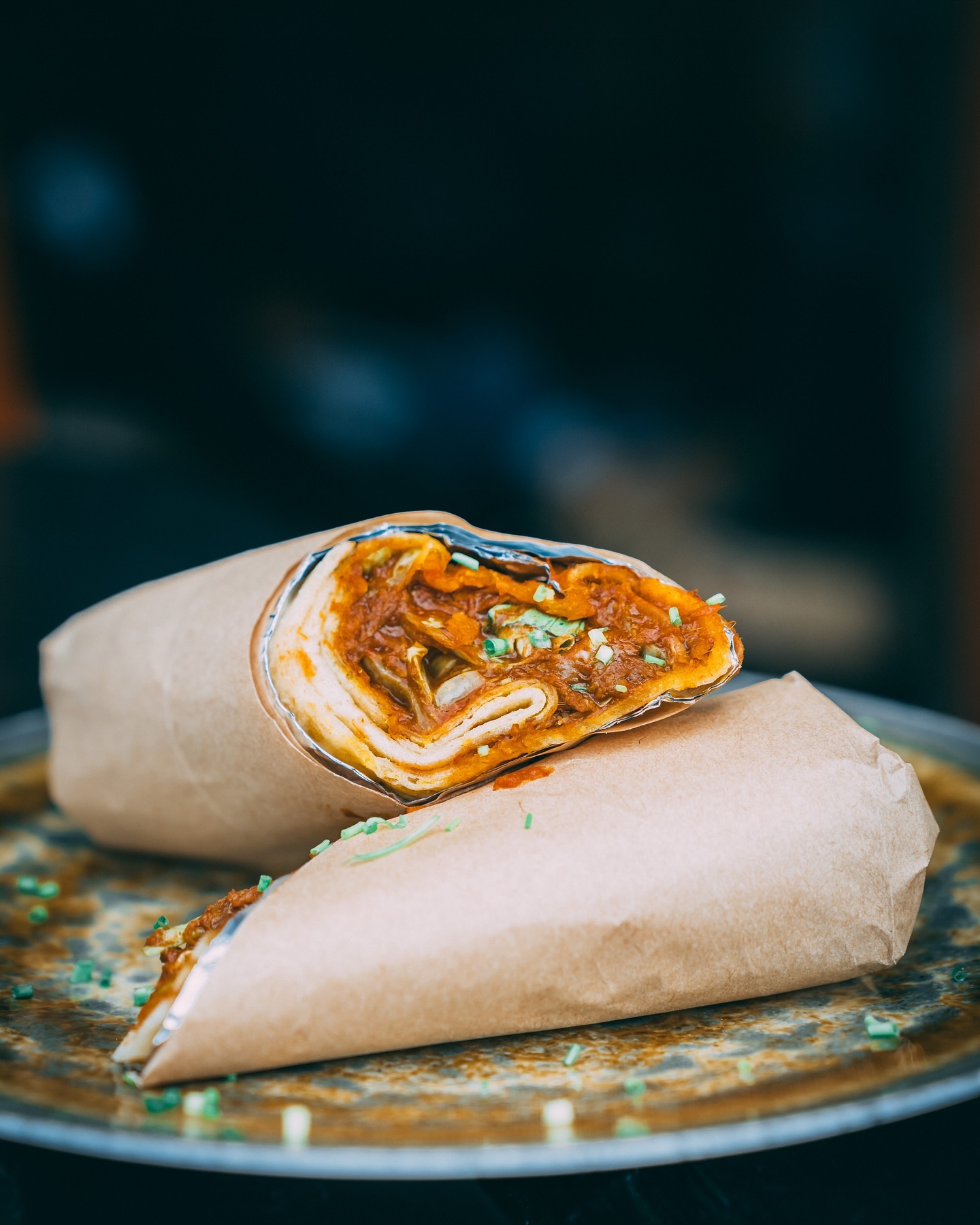 A wrapped dish filled with a savory mixture, garnished with green herbs, at Malva, a halal restaurant in Amsterdam, Netherlands.