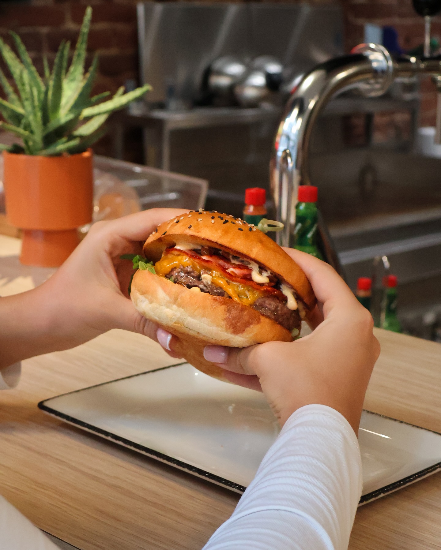 A burger with lettuce, cheese, and sauces at Just Burgers, a halal restaurant in Gorinchem, Netherlands.