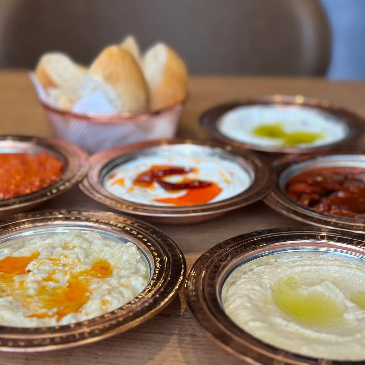 A selection of dips including hummus, red pepper dip, and yogurt sauce at Harbii, a halal restaurant in Rotterdam, Netherlands.