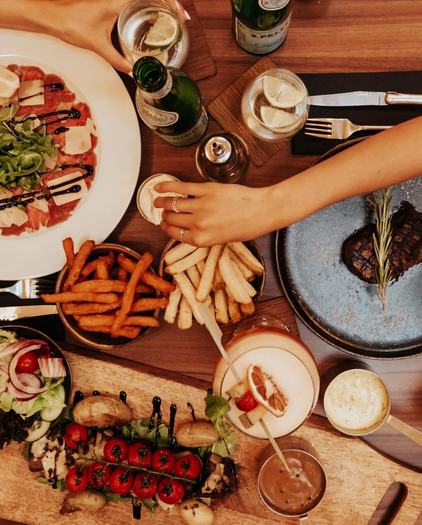 A variety of dishes including steak, sweet potato fries, and a salad at Le Petit La Ruche, a halal restaurant in Antwerpen, Belgium.