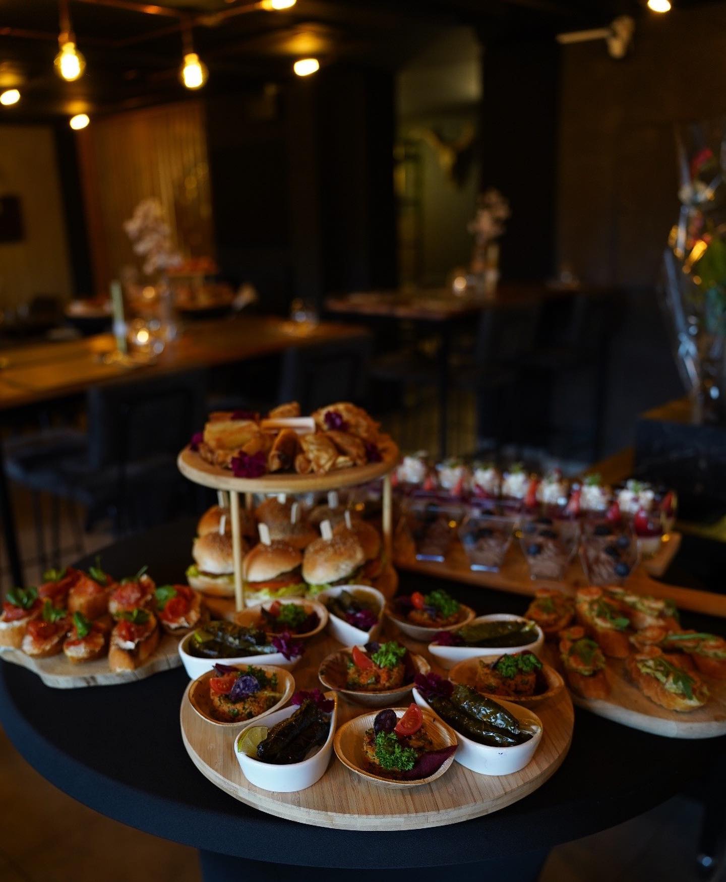 A variety of appetizers including mini burgers, pastries, and dips at Buffalo, a halal restaurant in Beringen, Belgium.