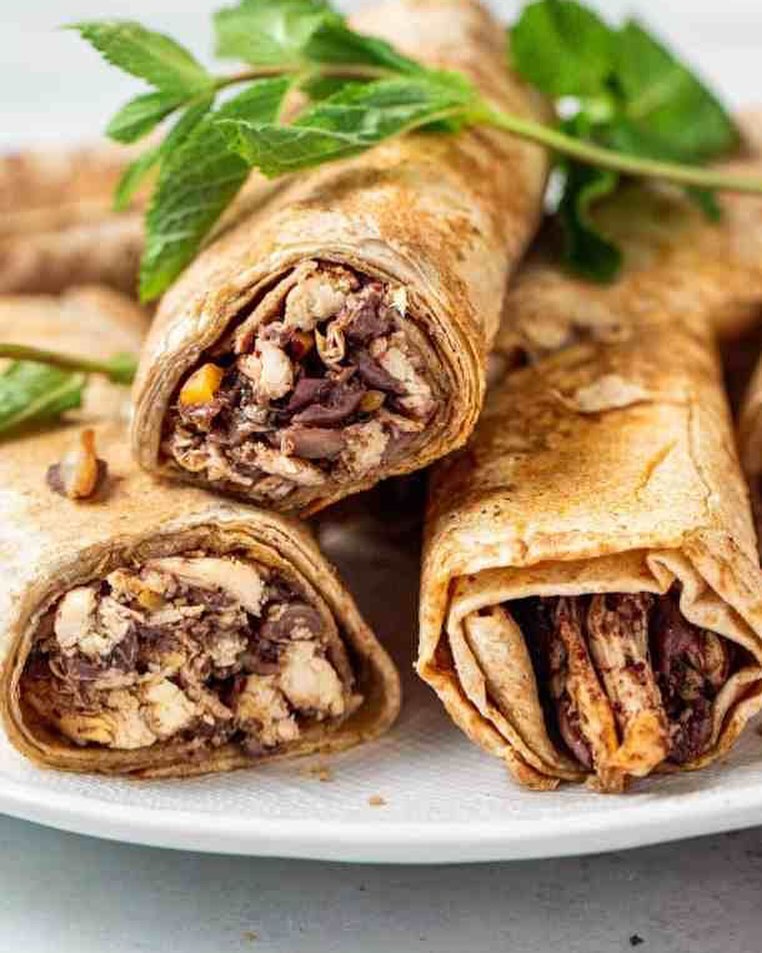 A plate of rolled flatbreads filled with chicken and beans at Olive, a halal restaurant in Saint-Gilles, Belgium.