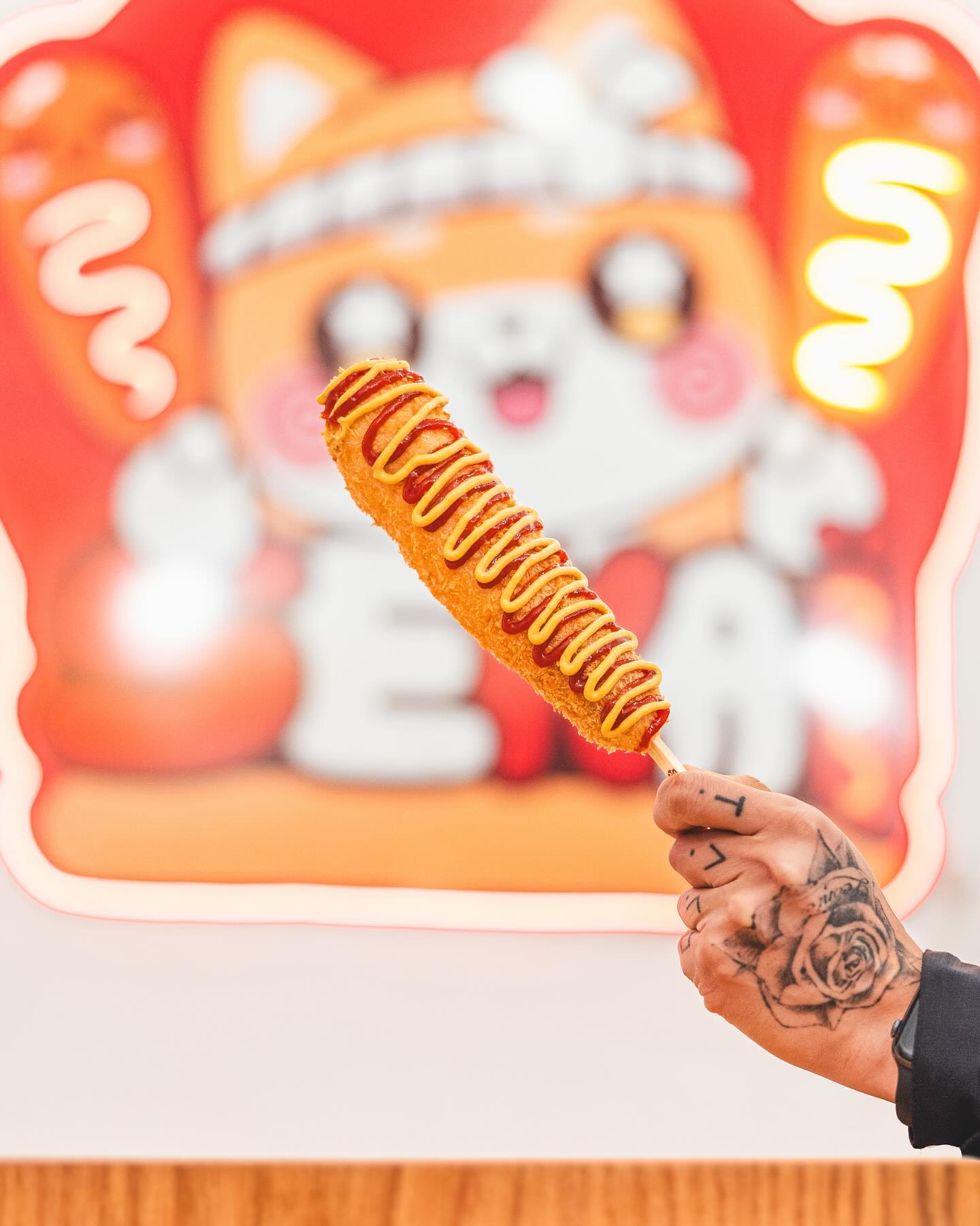 A corndog with ketchup and mustard at Sekaï Corndogs, a halal restaurant in Bruxelles, Belgium.