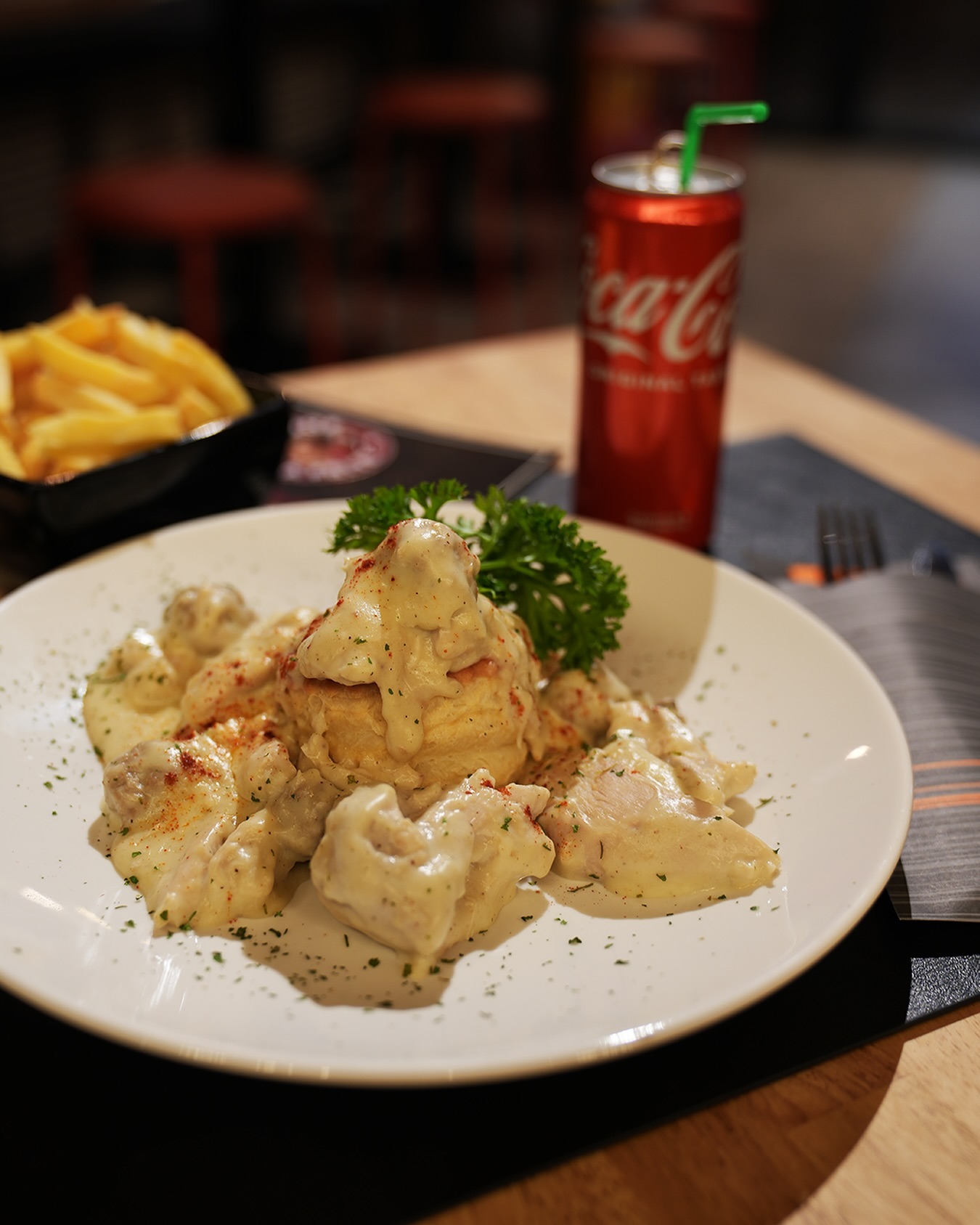 A plate of creamy chicken and biscuit dish at Joe La Frite, a halal restaurant in Bruxelles, Belgium.