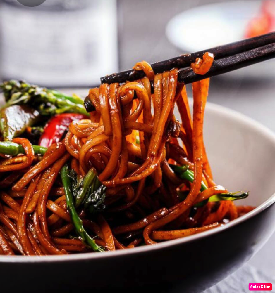A bowl of stir-fried noodles with vegetables at Leuven Chicken and Rice, a halal restaurant in Leuven, Belgium.