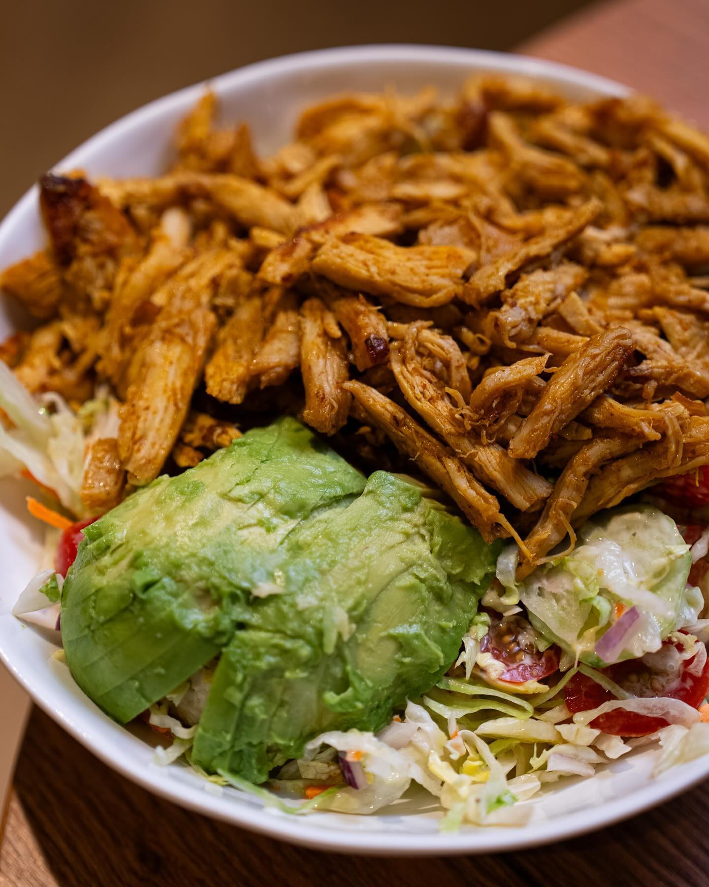 A bowl of shredded chicken and avocado on a bed of salad at Freshmade, a halal restaurant in Wijnegem, Belgium.