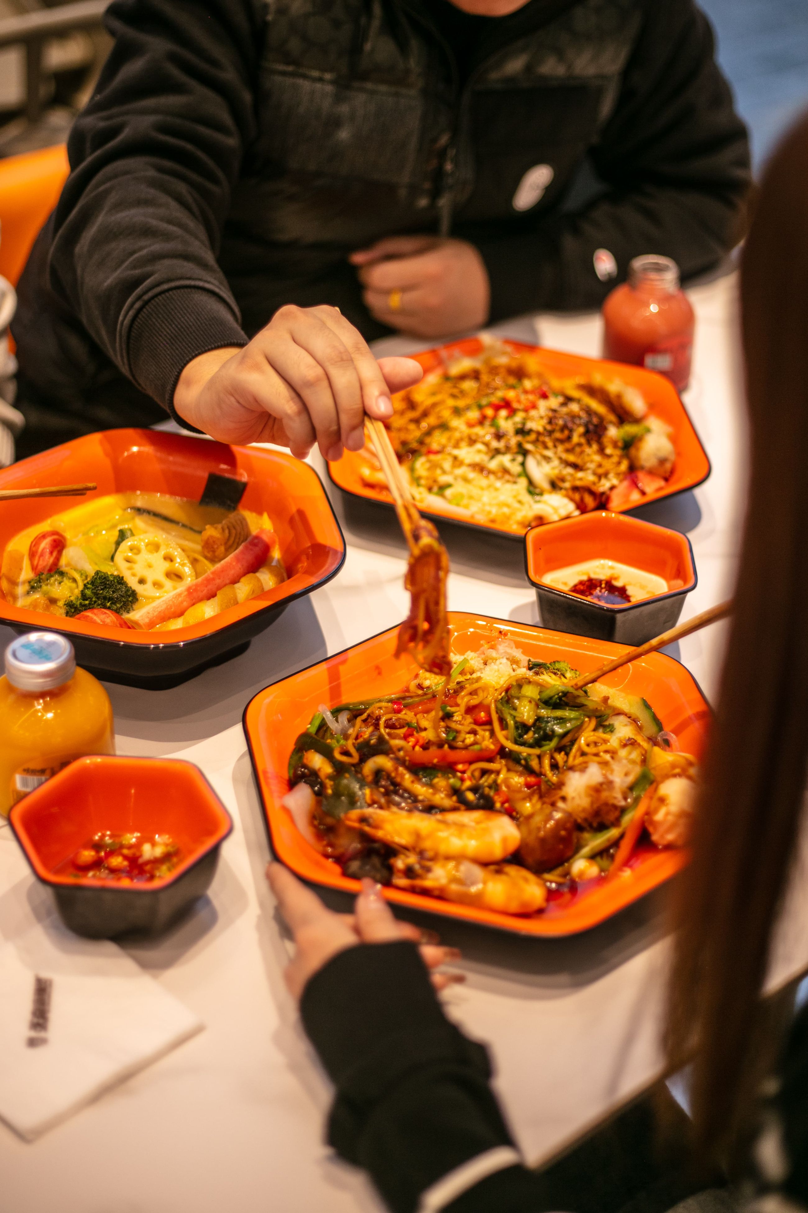A colorful noodle dish with shrimp and vegetables at ZLMLT, a halal restaurant in Rotterdam, Netherlands.