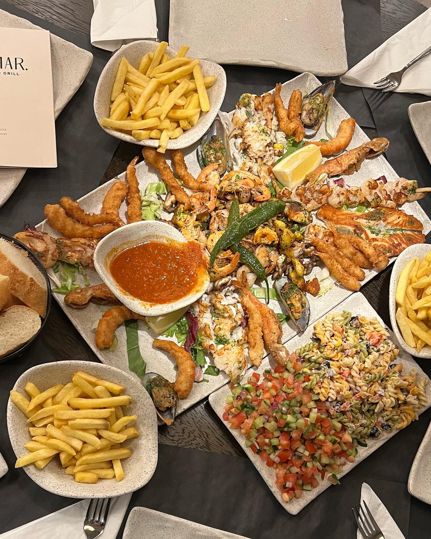 A seafood platter with shrimp, fish, and salad at Al Mar, a halal restaurant in Antwerpen, Belgium.