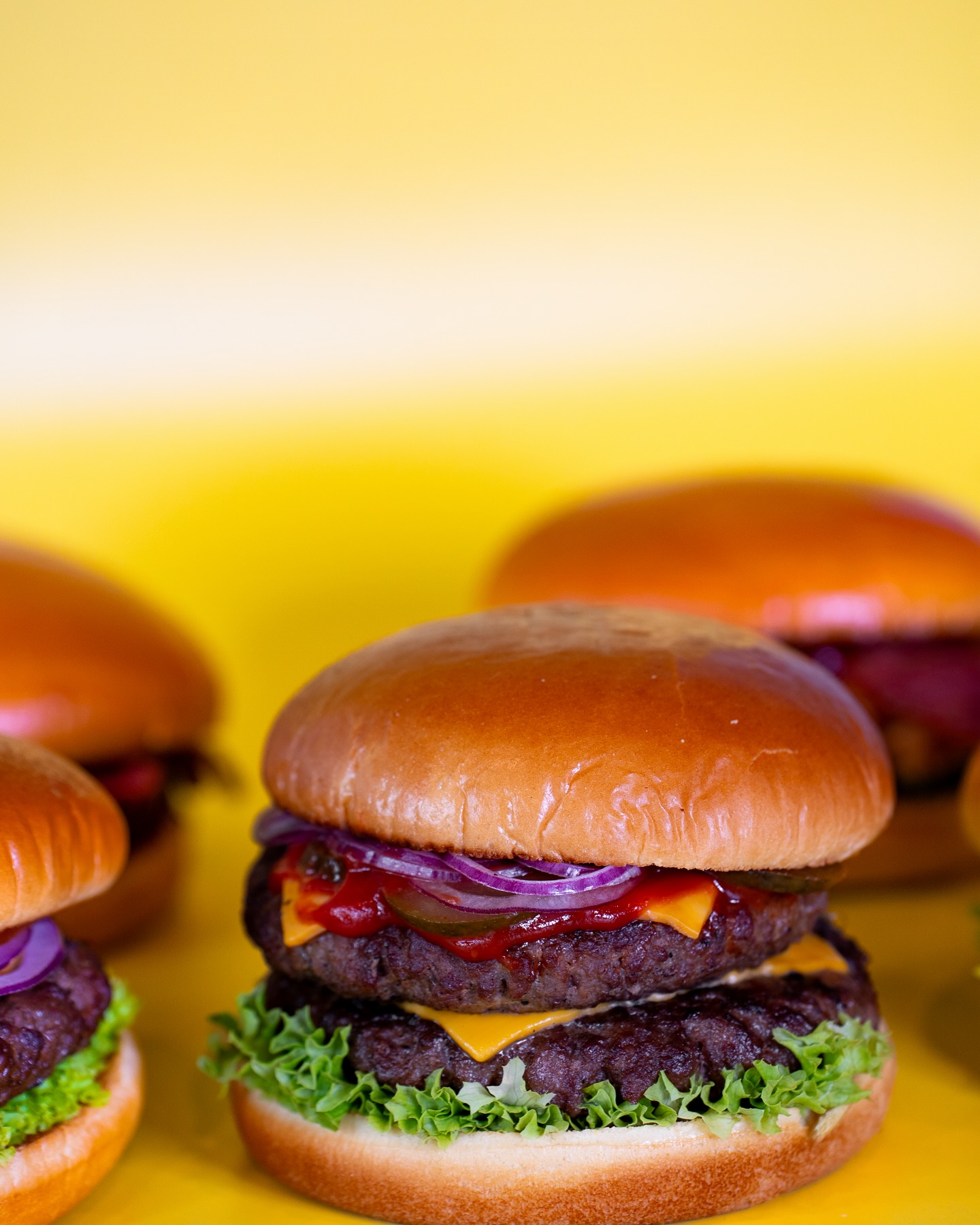 A close-up of a cheeseburger with lettuce, ketchup, and onions at King Ribs, a halal restaurant in Gent, Belgium.