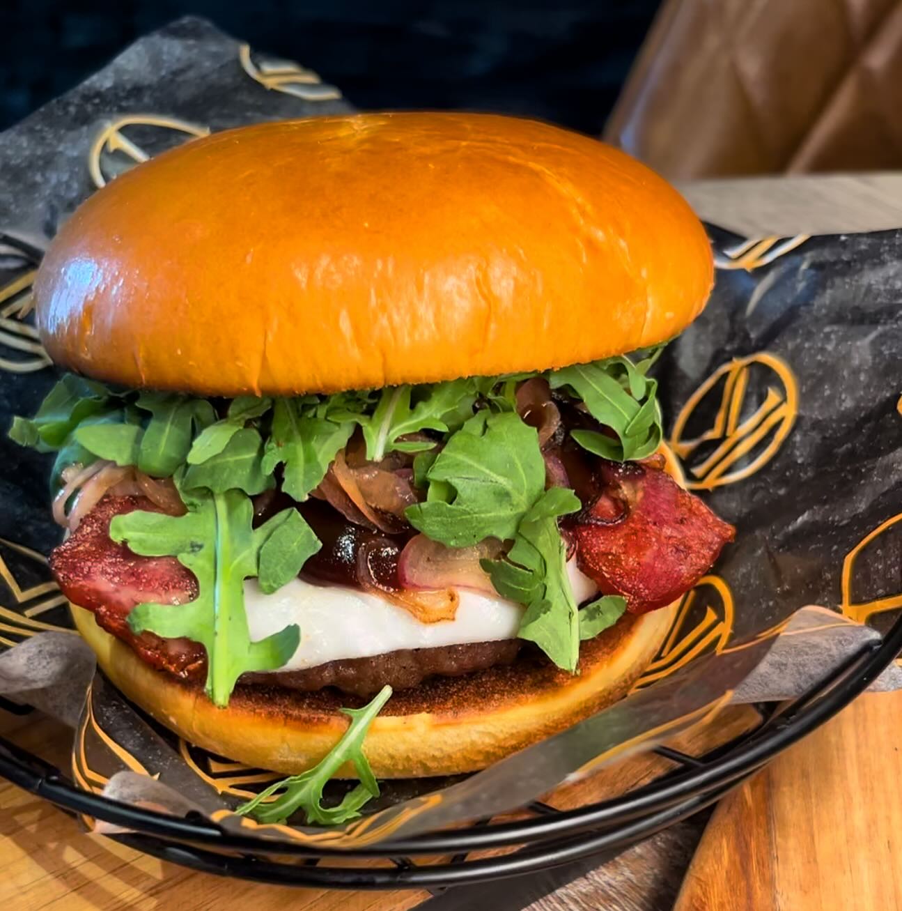 A burger with arugula, bacon, and sauce at King Ribs, a halal restaurant in Gent, Belgium.